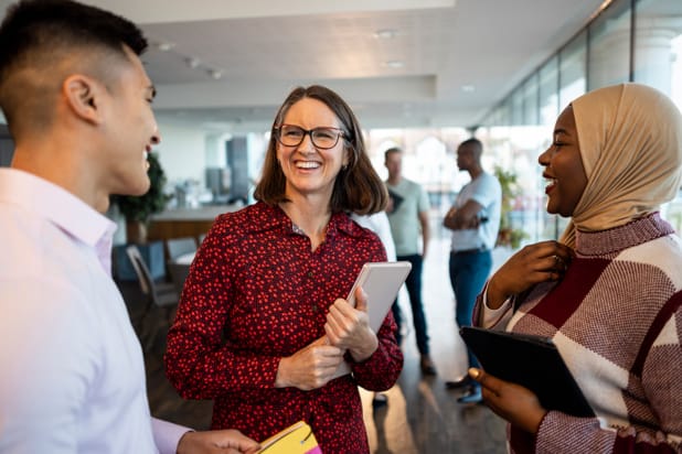 People chatting at a conference