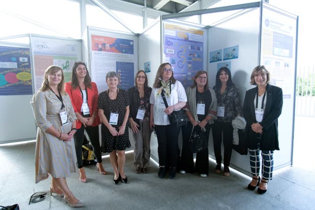 Group of women stood in front of conference posters