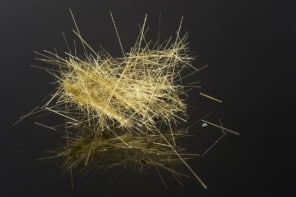 Pele's hair on a glossy black surface