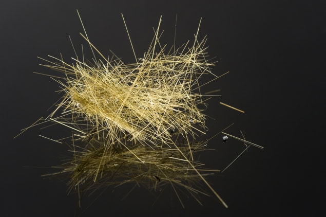 Pele's hair on a glossy black surface