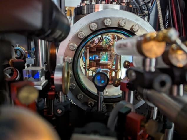 Photo of the vacuum chamber containing the rubidium MOT, surrounded by optics and imaging systems