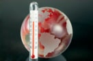 Illustration of planet Earth next to a thermometer