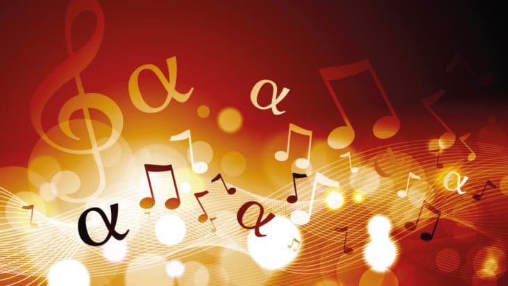 Musical notes and the alpha symbol against blurred red and orange bokeh background