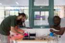 Julian Stirling and Valerian Sanga assembling a microscope display at the Gathering for Open Science Hardware in Shenzhen, China.